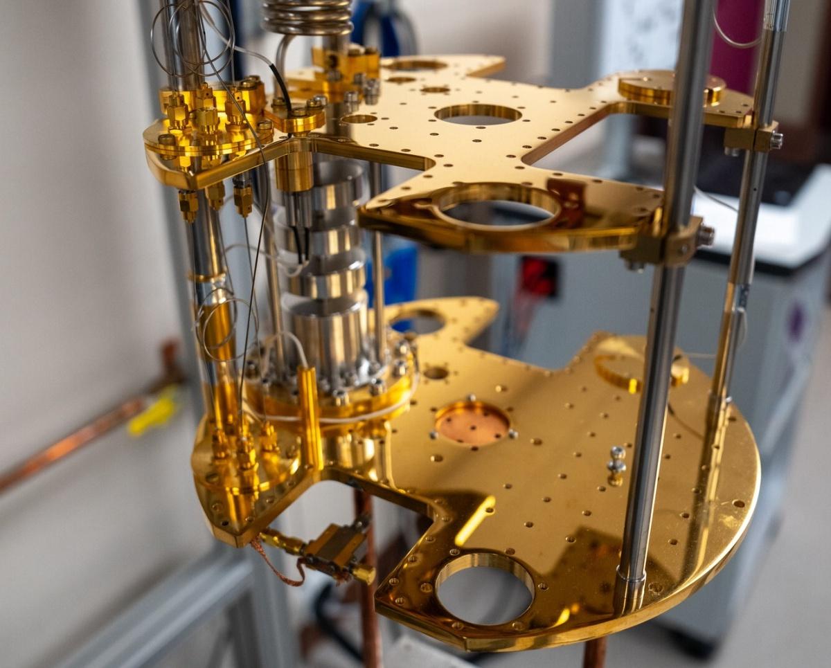 Gold-colored scientific apparatus stacked in a dilution refrigerator